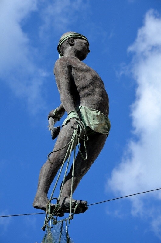 Tightrope fisherman statue