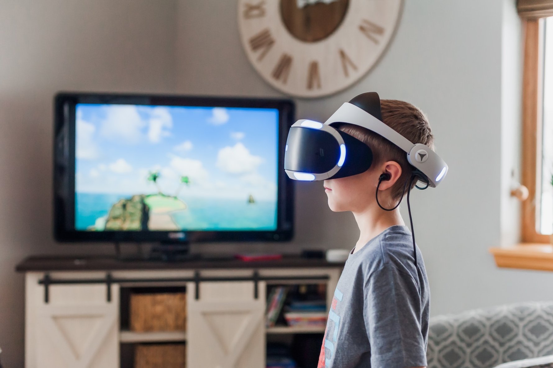 kid wearing VR headset with television